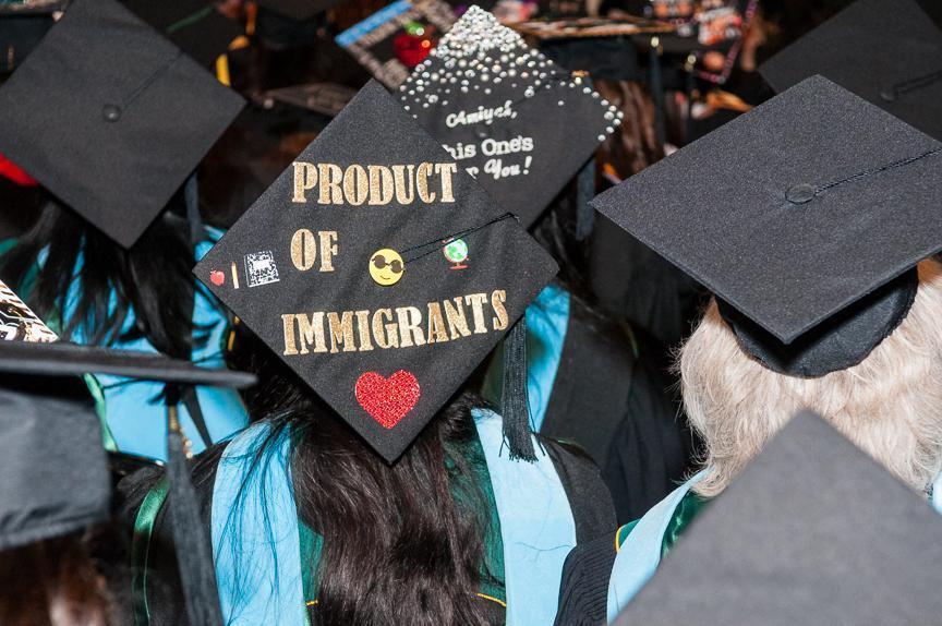 Graduation cap decorated with words Products of Immigrants