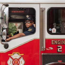 firefighter in firetruck with sunglasses