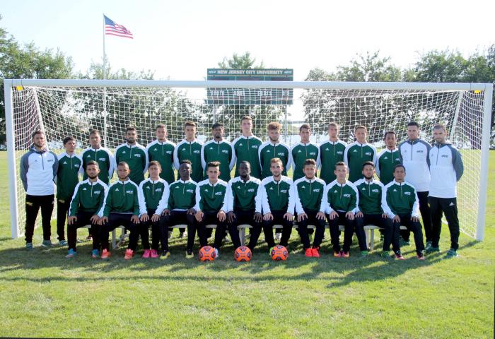 NJCU men's soccer team posing in front of a goal post and net.