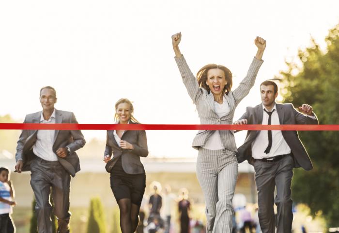 Business people running to finish, crossing red line. - stock photo GettyImages-170431775