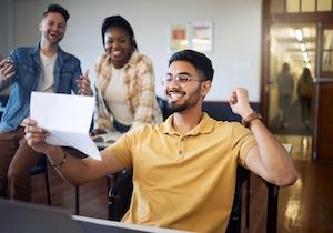 students cheering over acceptance-paper small