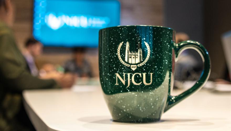 NJCU logo Coffee Cup on a table