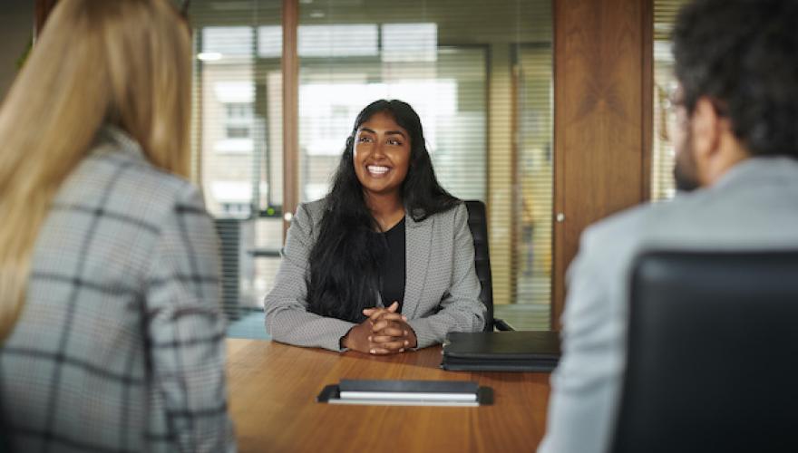 SMILING WOMAN AT INTERVIEW